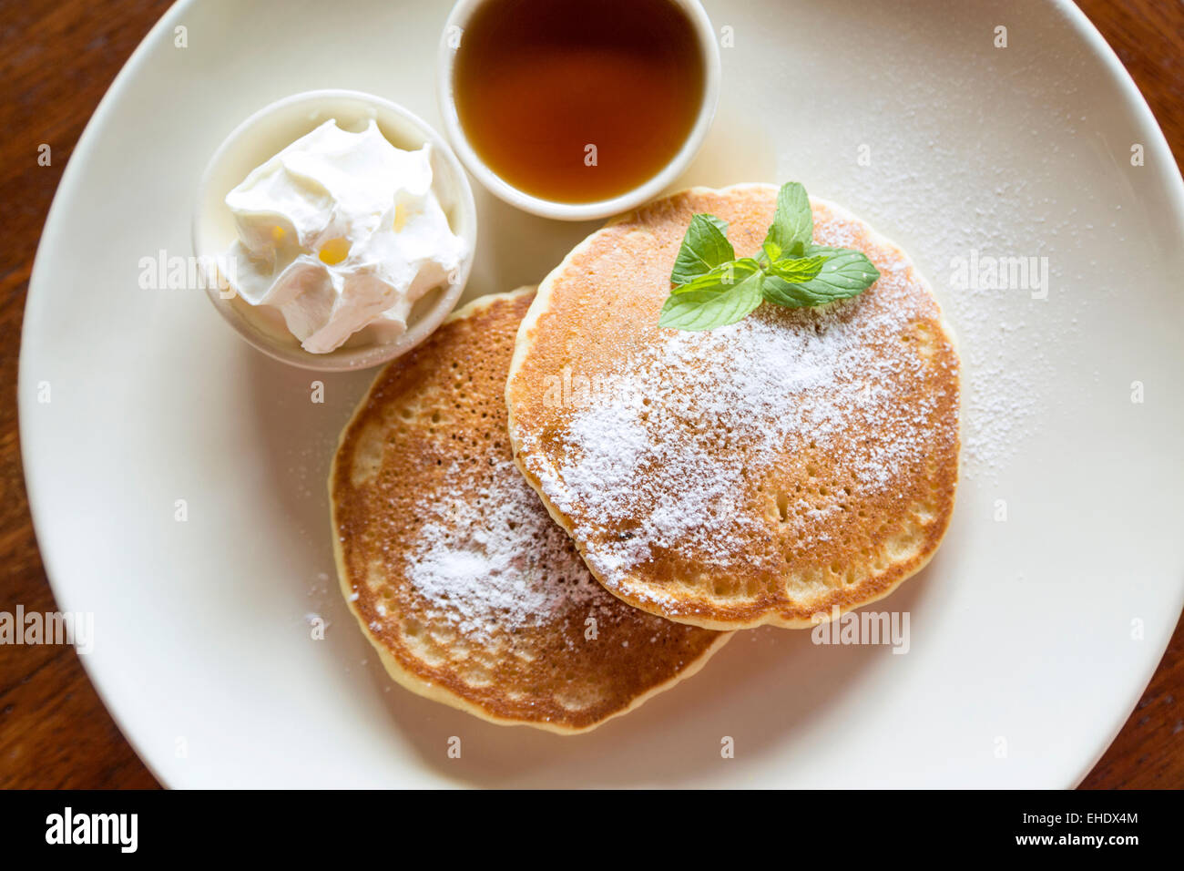 Two pancakes with maple syrup and whipped cream Stock Photo Alamy