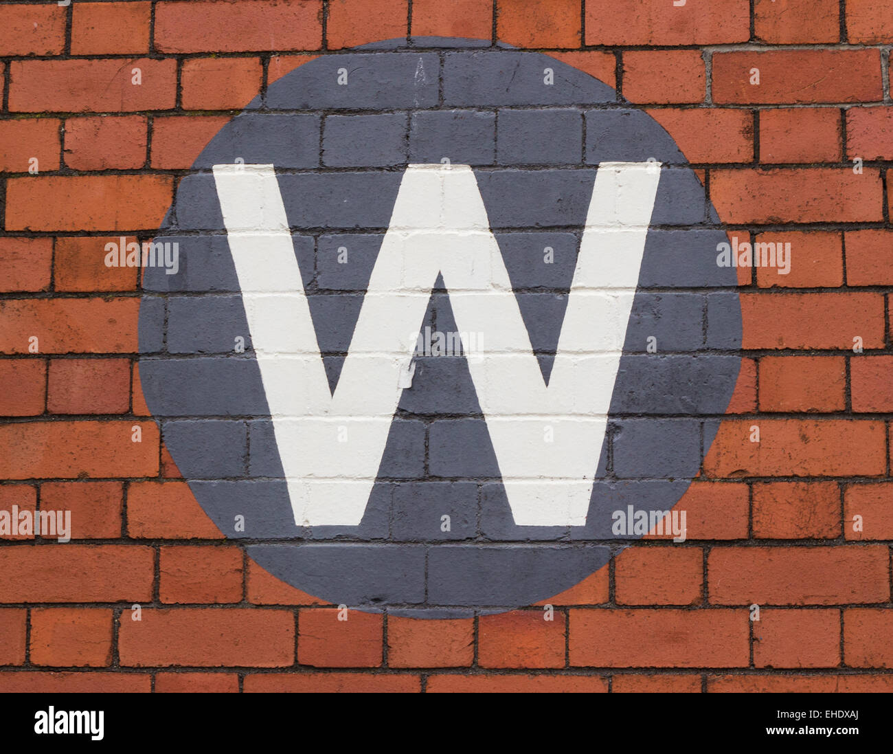 Letter W painted on red bricks Stock Photo - Alamy