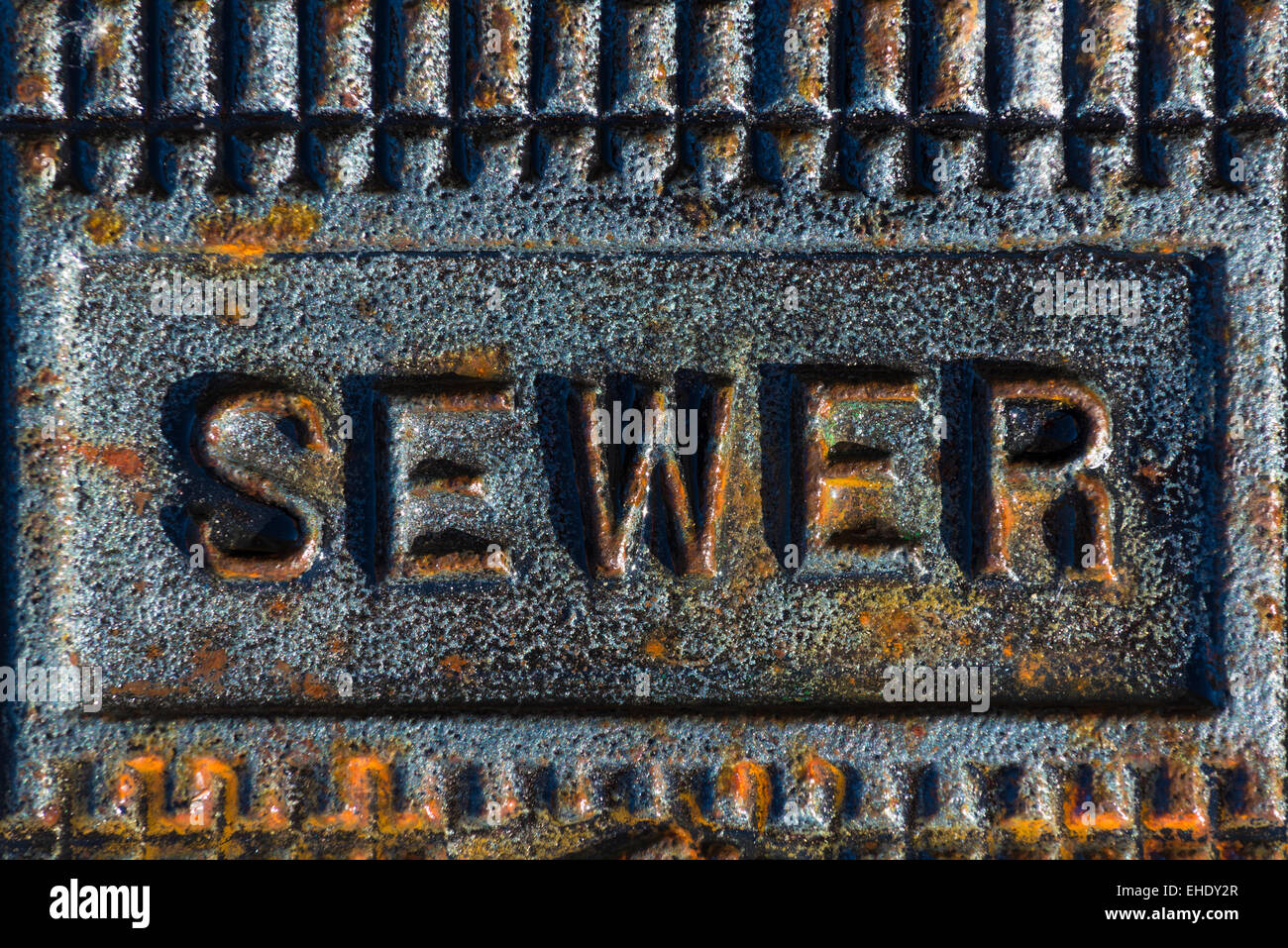 A sewer access cover with rusty iron printing Stock Photo - Alamy