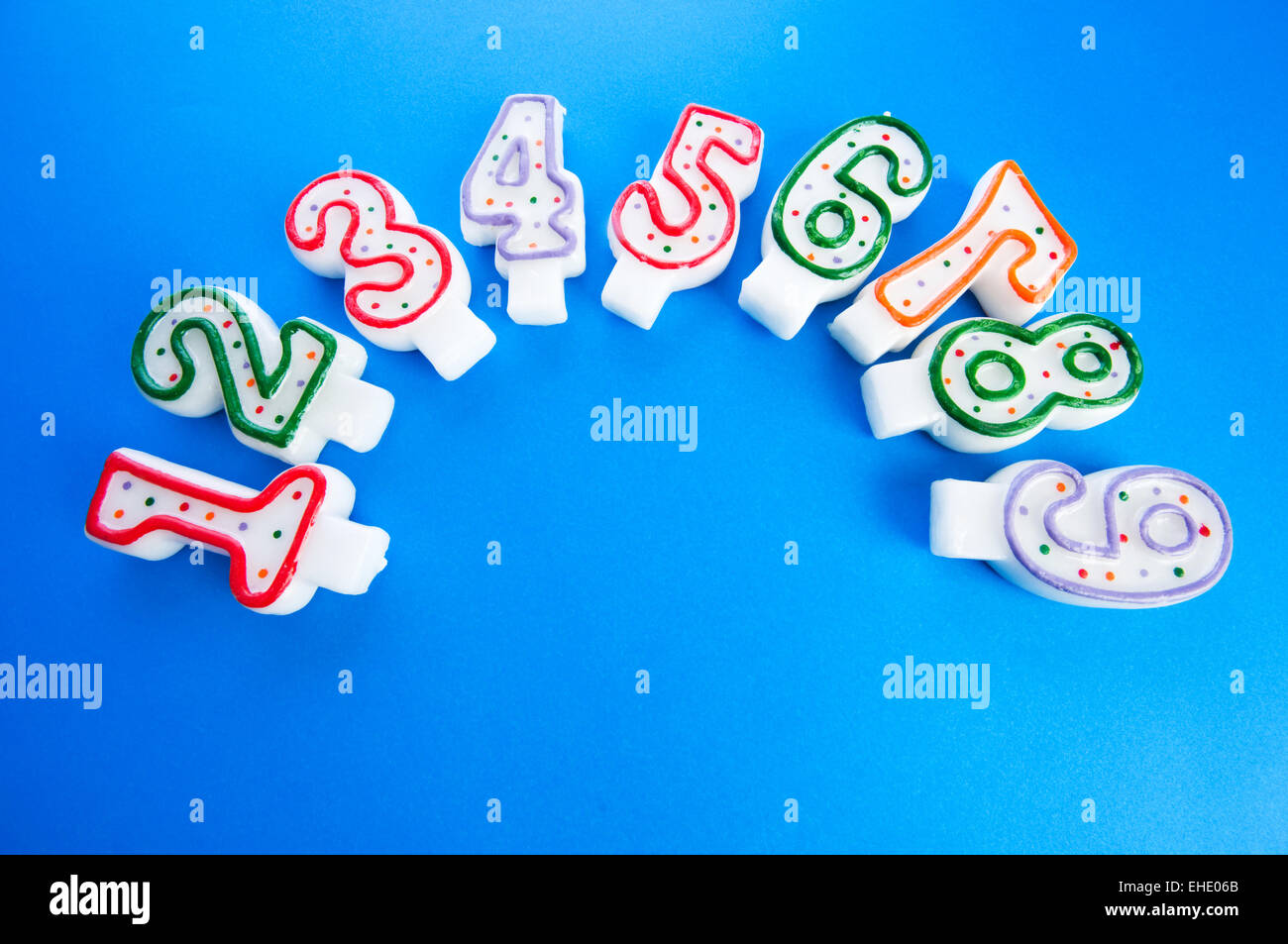 Birthday candles against colourful background Stock Photo - Alamy