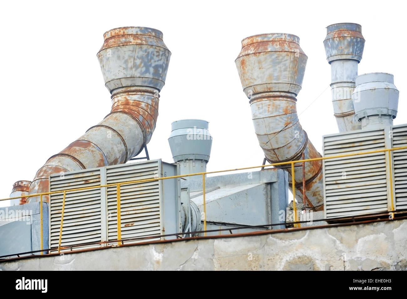 Industrial shot with big exhaust pipes on the roof of a plant Stock Photo