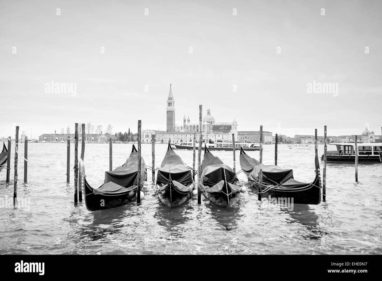 A view of the Church of San Giorgio Maggiore with gondolas parked in the water canal on Riva degli Schiavoni in Venice, Italy. Stock Photo