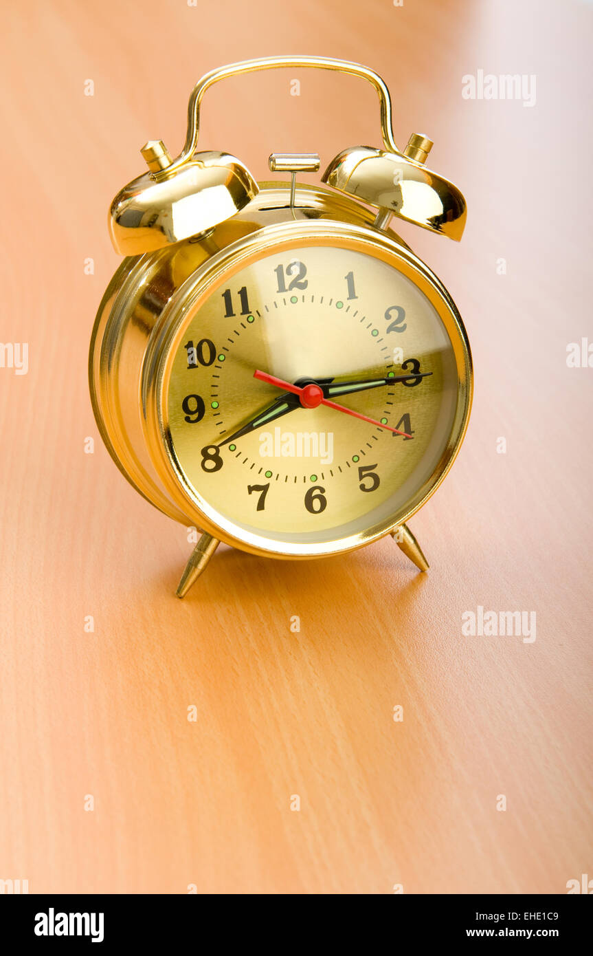 Alarm clock on the wooden table Stock Photo - Alamy