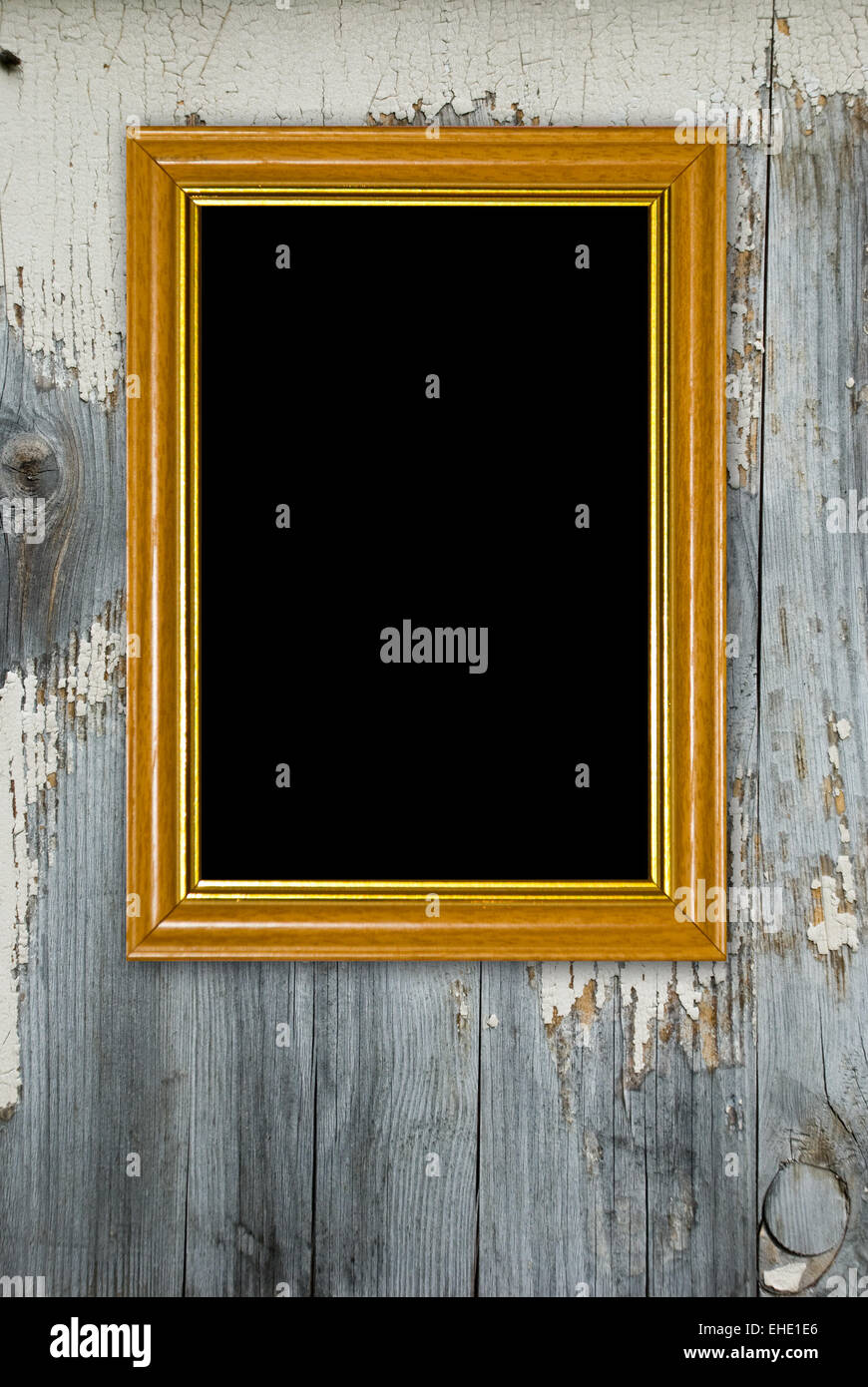 Gold frame on a old wooden wall background Stock Photo - Alamy