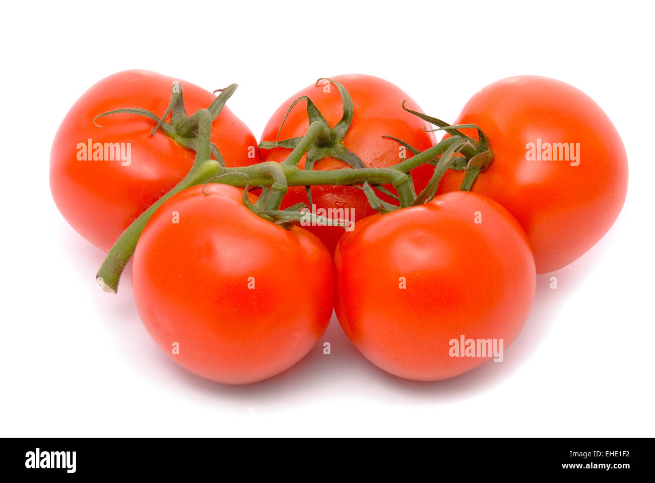 Fresh tomatoes isolated on white. Stock Photo