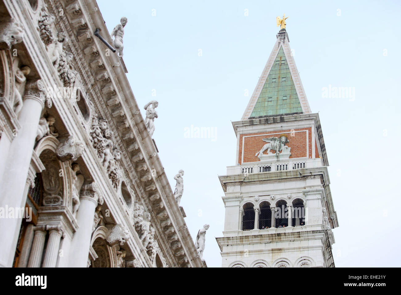 A low angle view of top of the San Marco campanile and the Marciana National Library on the Piazza San Marco in Venice, Italy. Stock Photo