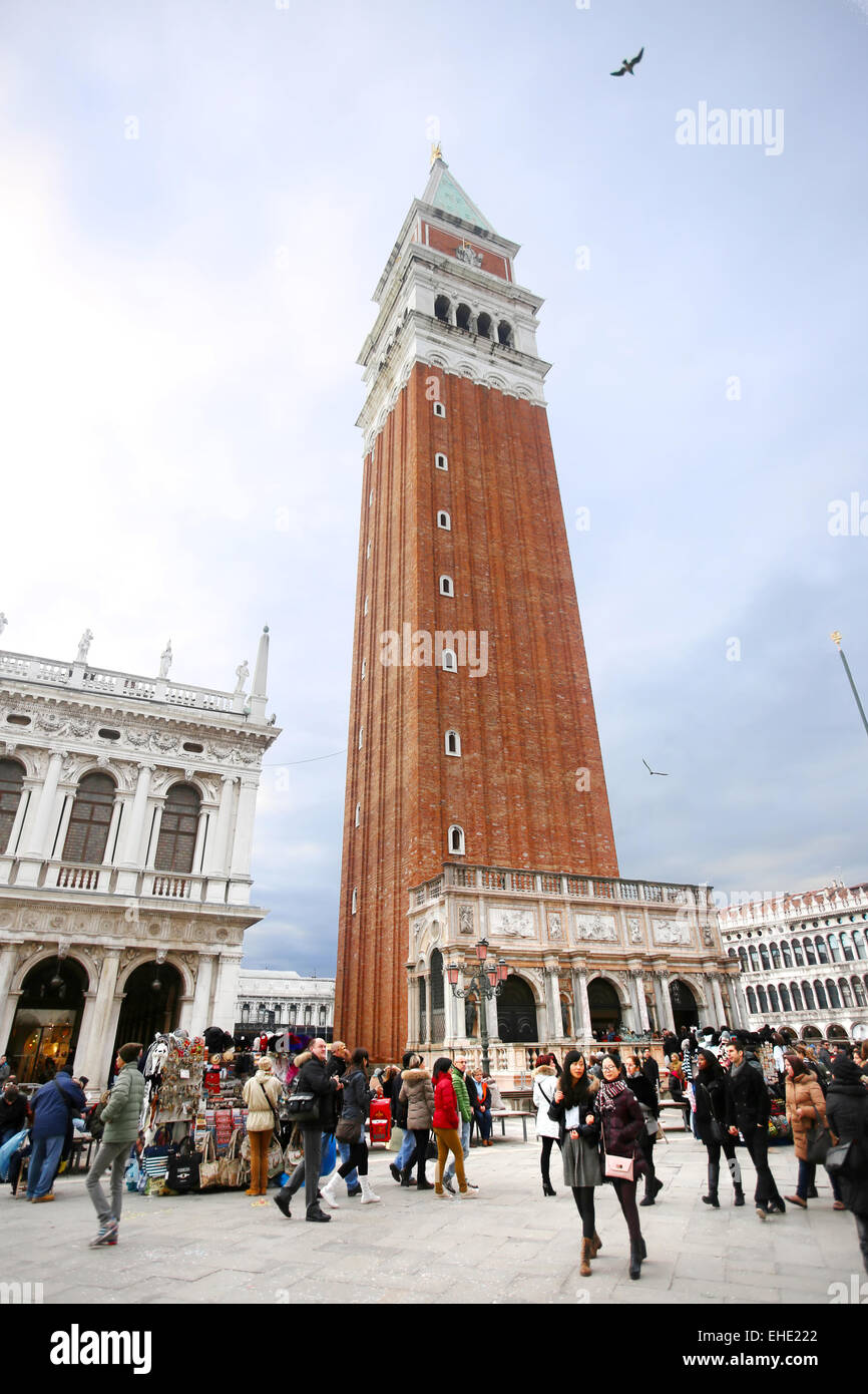 People walking on the San Marco square next to the Saint Mark campanile and the Marciana National Library in Venice, Italy. Stock Photo