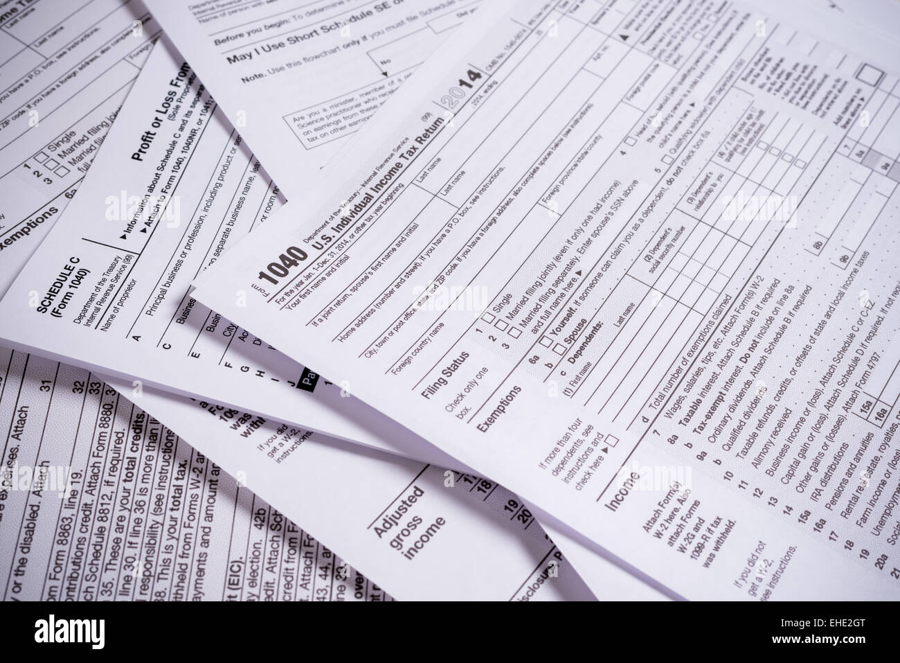 A variety of United States tax forms with a pencil Stock Photo