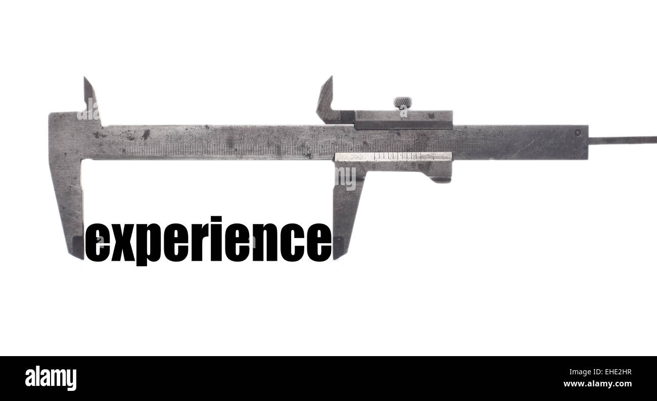 Color horizontal shot of a caliper measuring the word "experience Stock