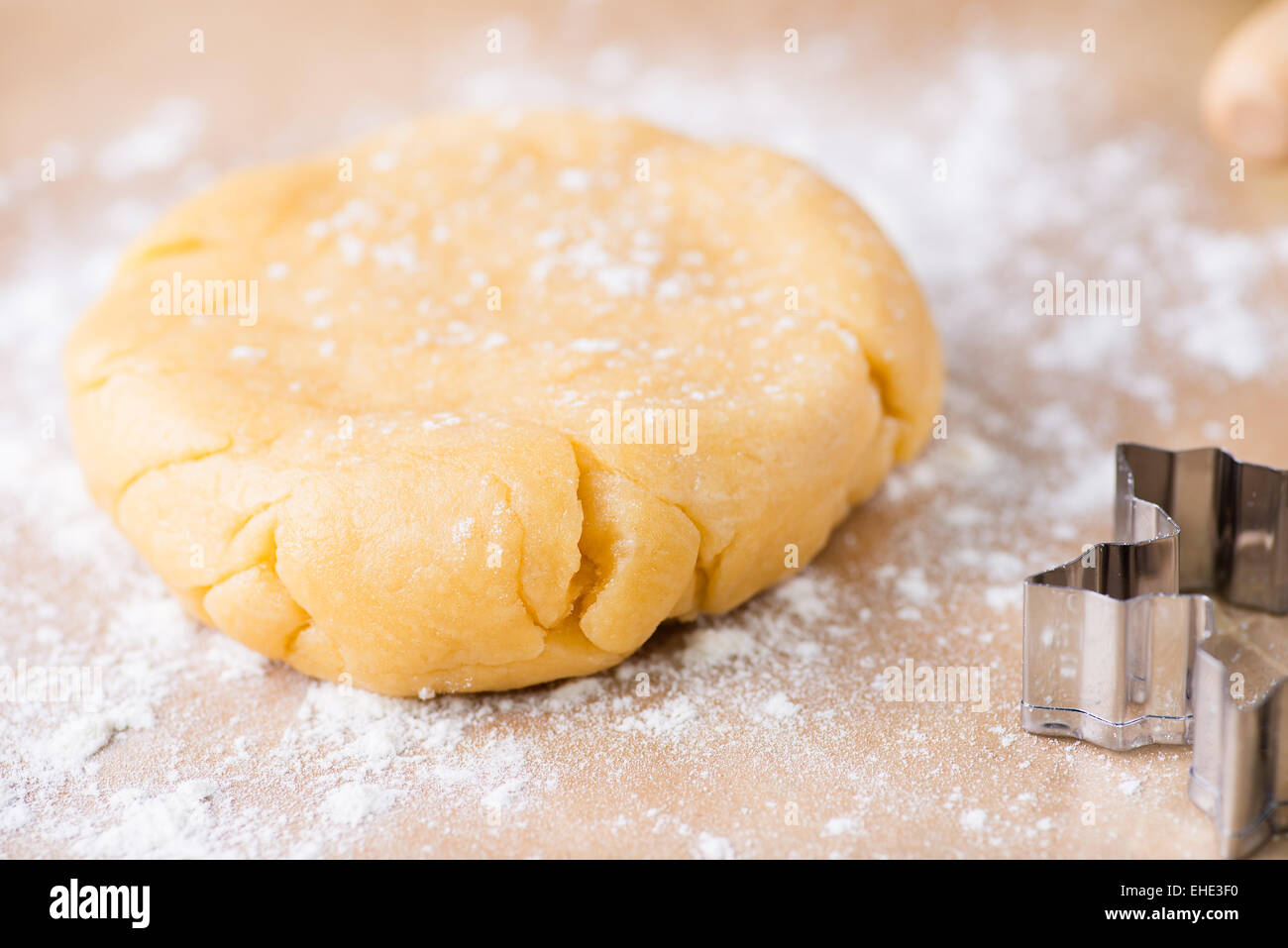 Shortcrust pastry dough, unrolled and unbaked on a floured surface, closeup, selective focus Stock Photo