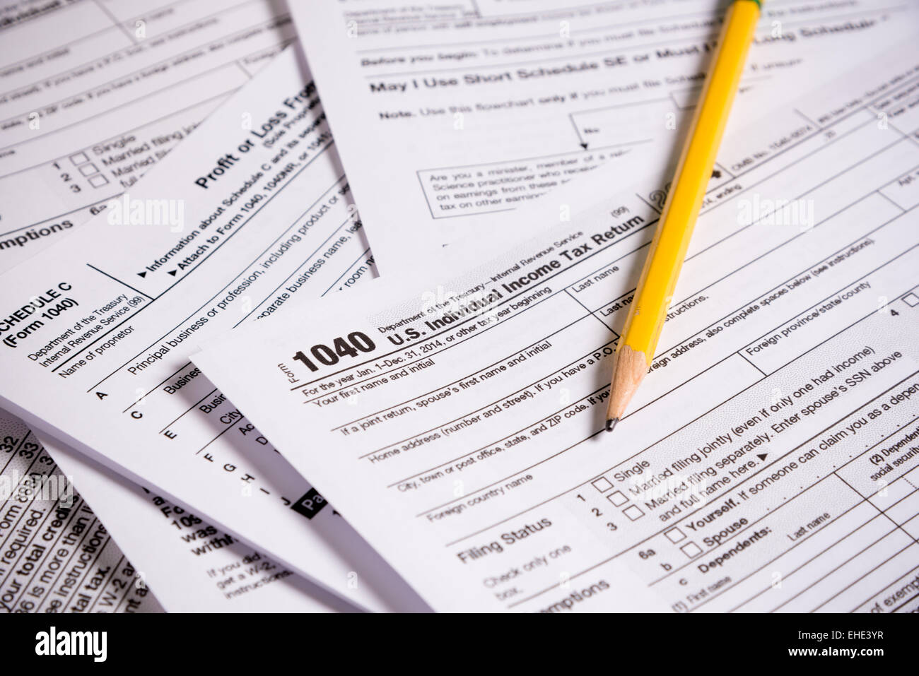 A variety of United States tax forms with a pencil Stock Photo