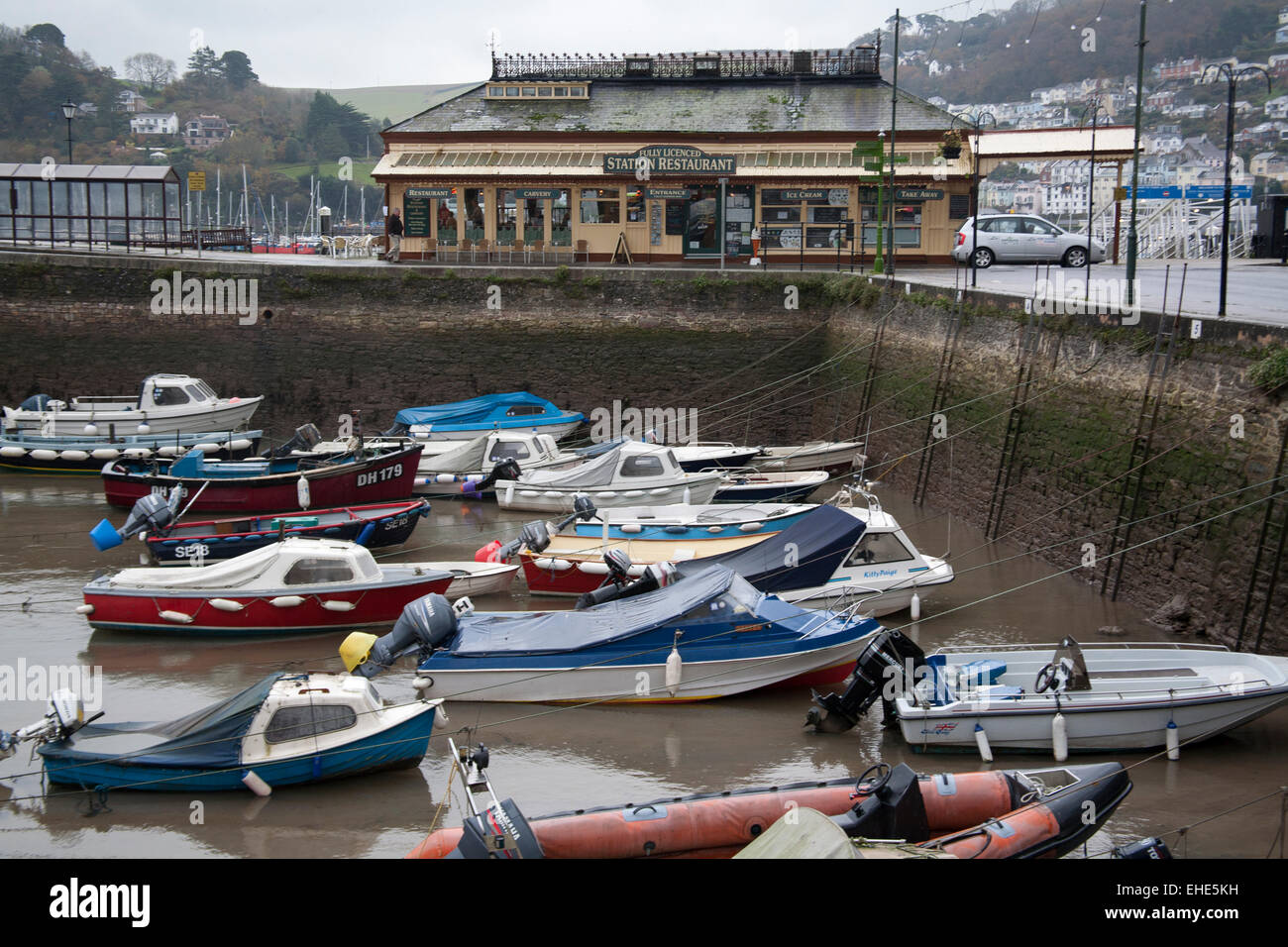 The Station Restaurant and moored boats in the harbour South Embankment, Dartmouth TQ6 9BH Stock Photo