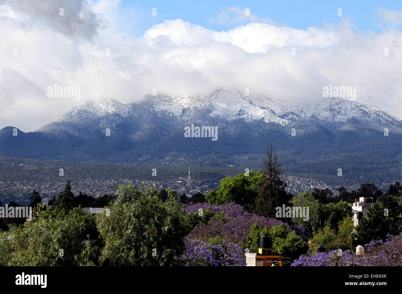 Mexico City, Mexico. 12th Mar, 2015. Clouds loom over the Ajusco Hill in Mexico City, capital of Mexico, on March 12, 2015. The Ajusco Hill dawned snowy due to the low temperature by cold front, according to local press. © Jose Pazos/NOTIMEX/Xinhua/Alamy Live News Stock Photo