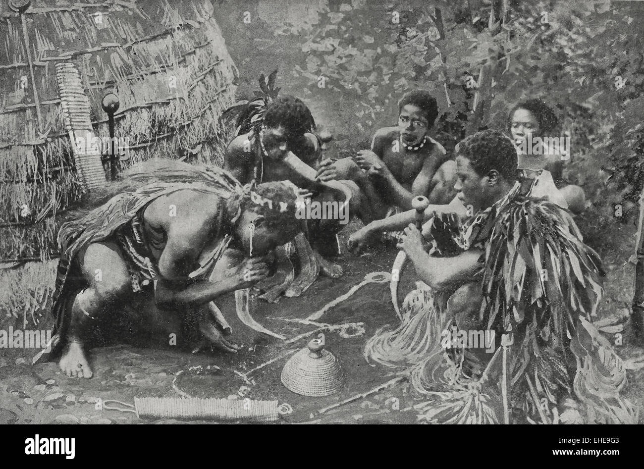 Dagga Smokers - This group of natives is smoking Indian hemp which is buried in the ground.  The instrument used is either a hollow reed or, in this instance, the horns of cattle.  It is a pernicious habit, as the smoke produces stupefaction and sometimes delirium. Circa 1895 Stock Photo