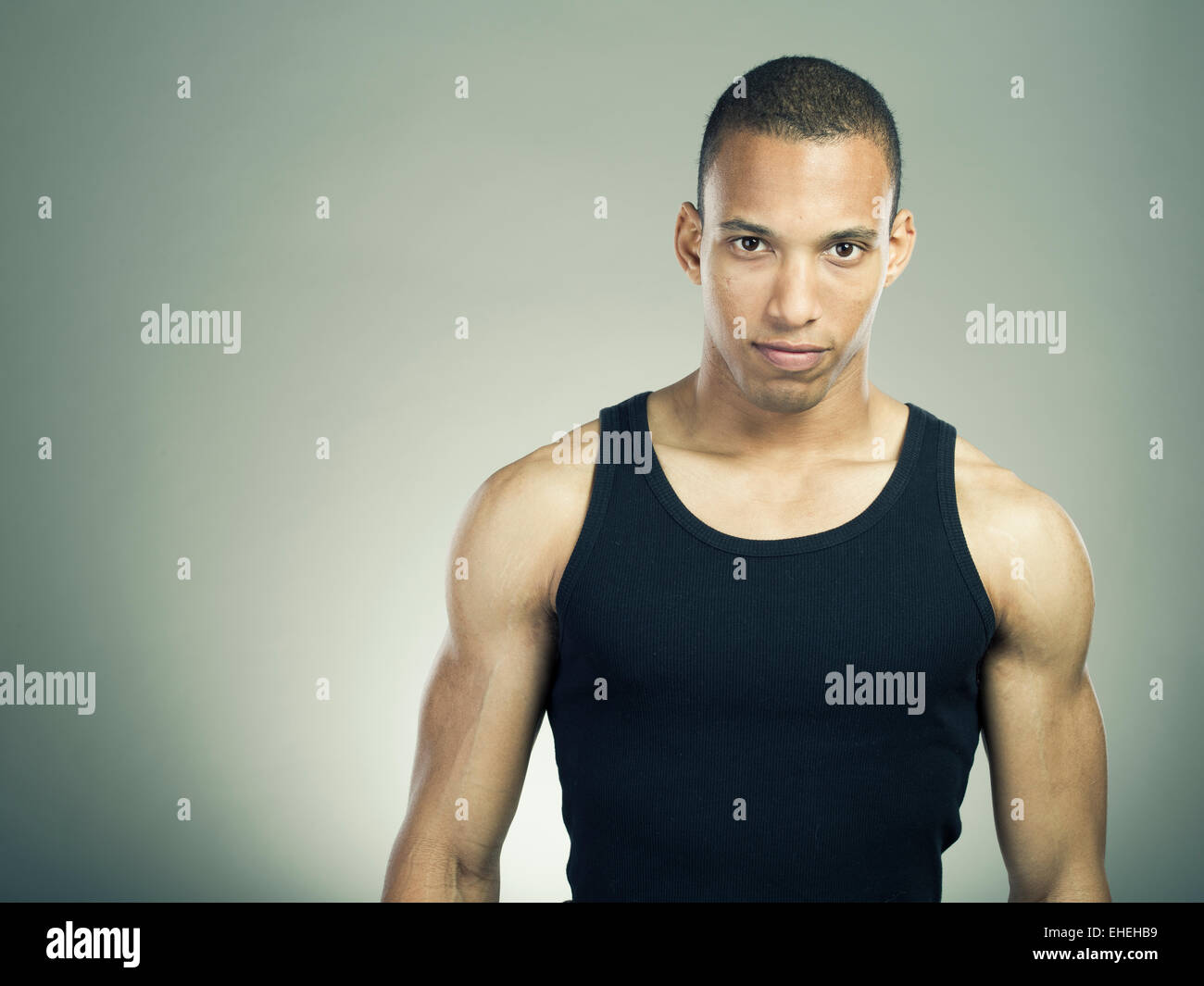 Muscular man wearing black tank top vest Stock Photo