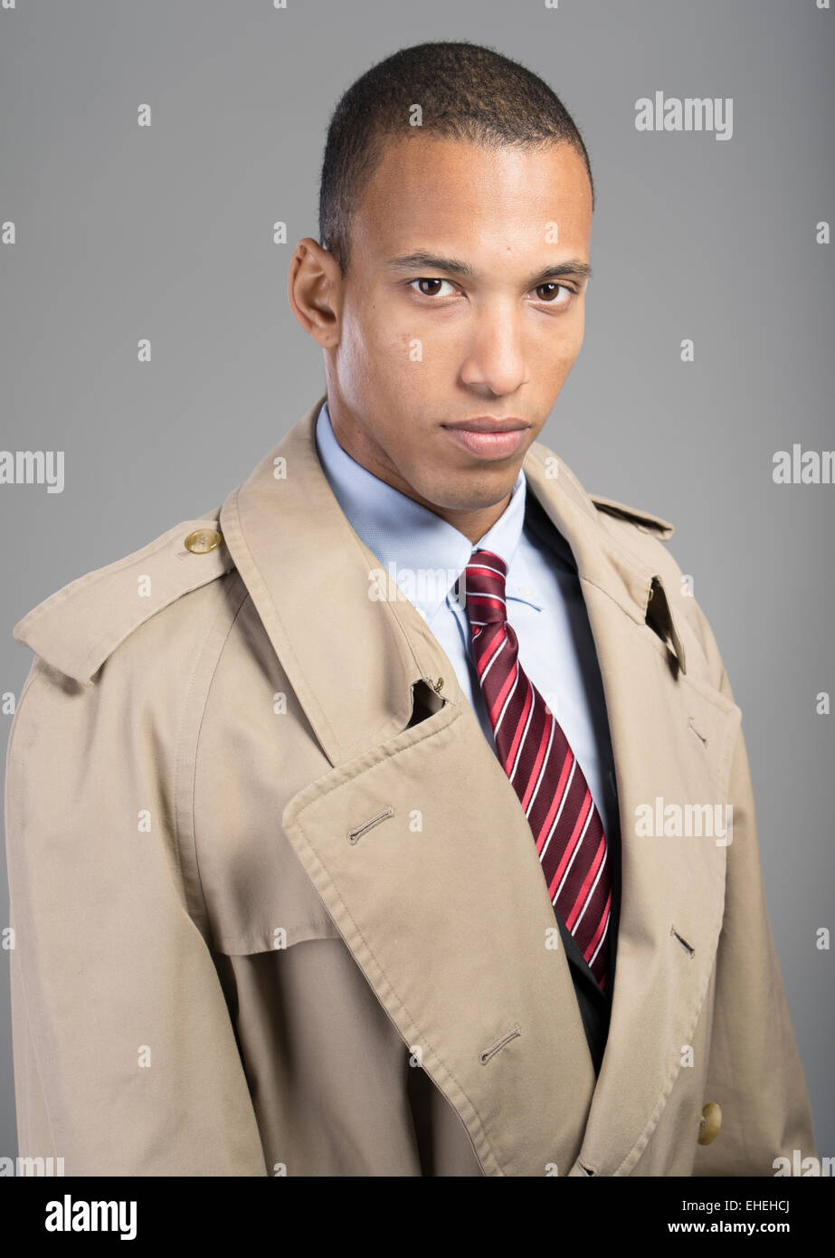 Businessman wearing suit tie and beige Burberry trench coat Stock Photo