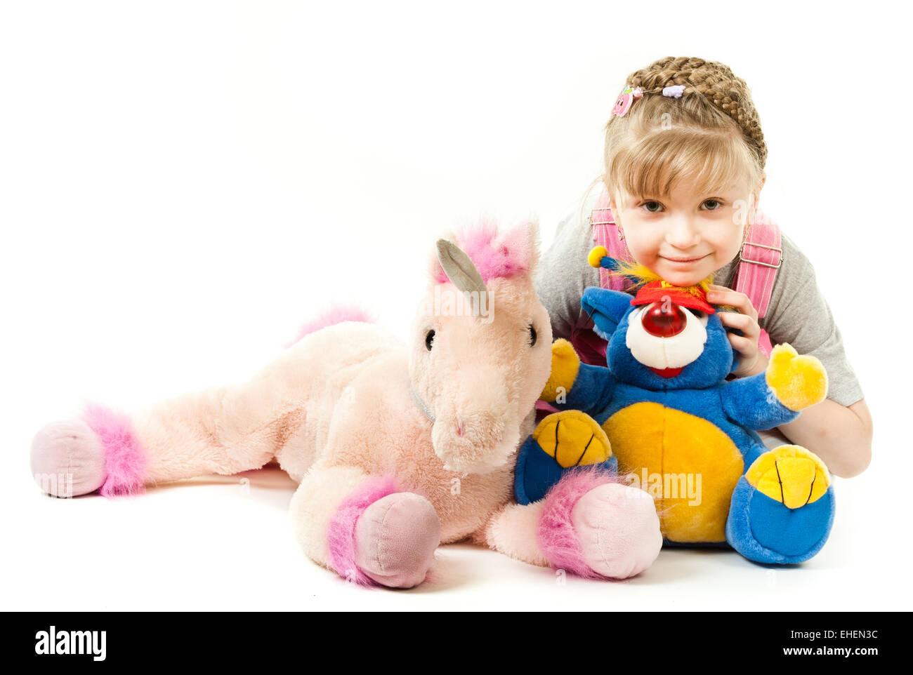 Girl surrounded by her toys Stock Photo