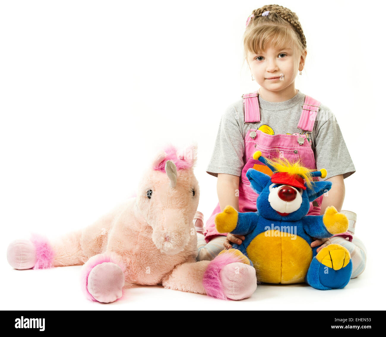 Girl surrounded by her toys Stock Photo