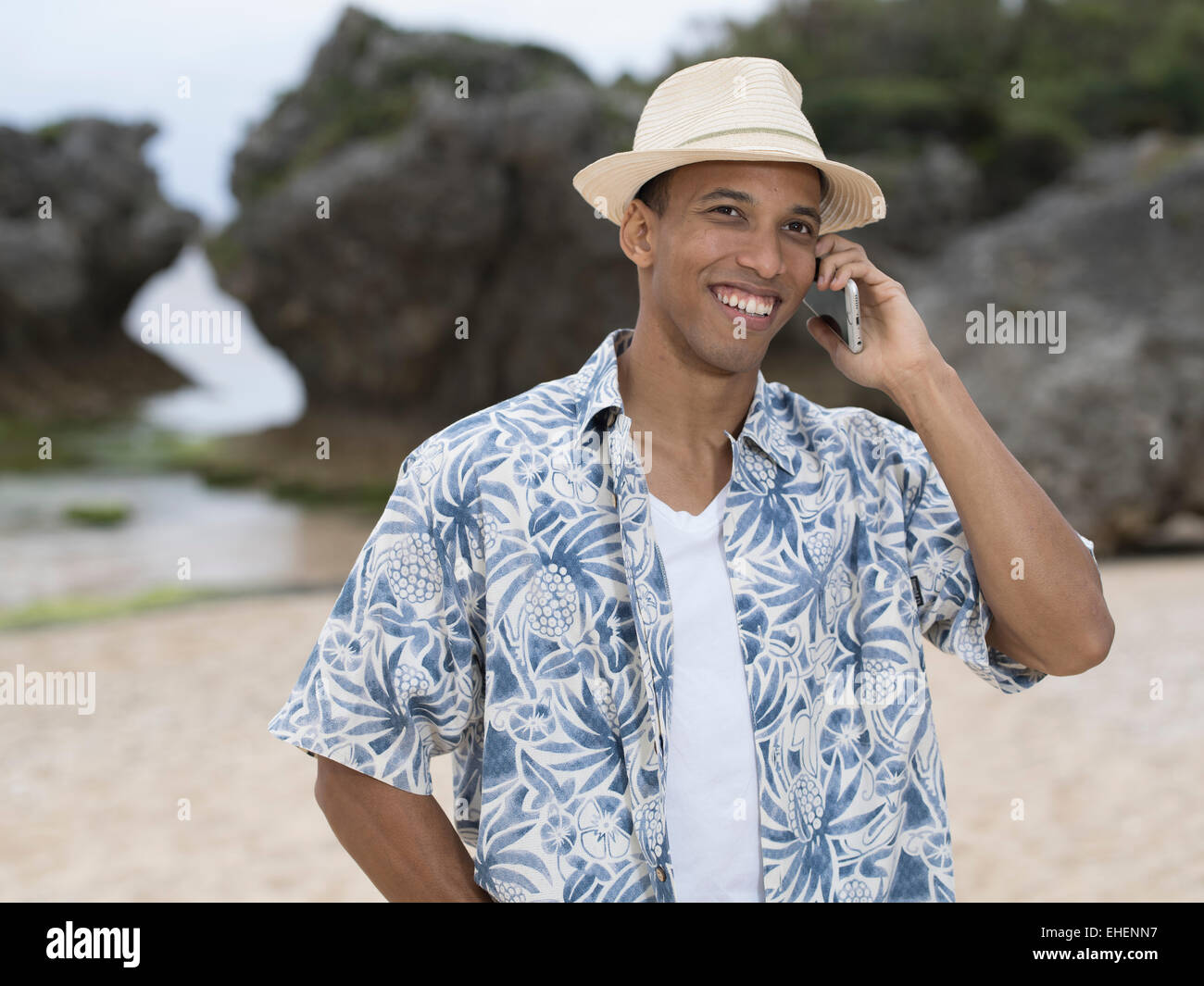Man calling / telephoning with Apple iphone 6 smartphone while at the beach Stock Photo