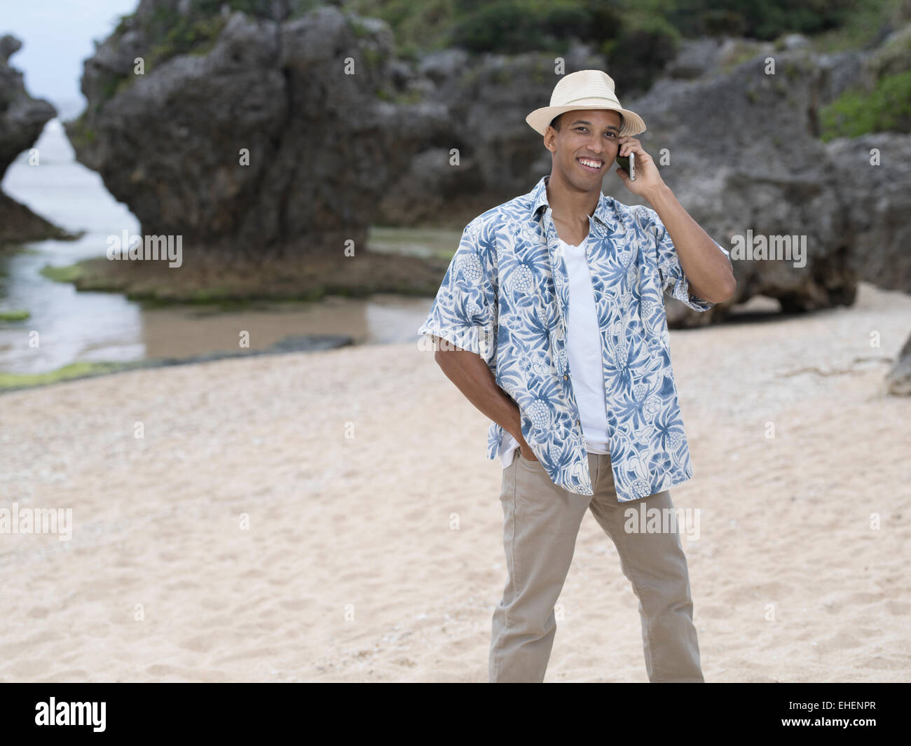 Man calling / telephoning with Apple iphone 6 smartphone while at the beach Stock Photo