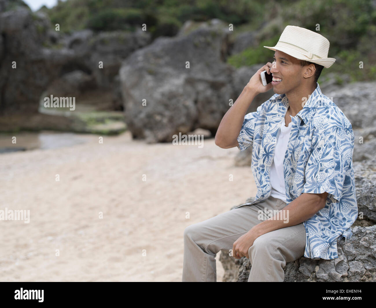 Man calling / telephoning with Apple iphone 6 smartphone while at the beach Stock Photo