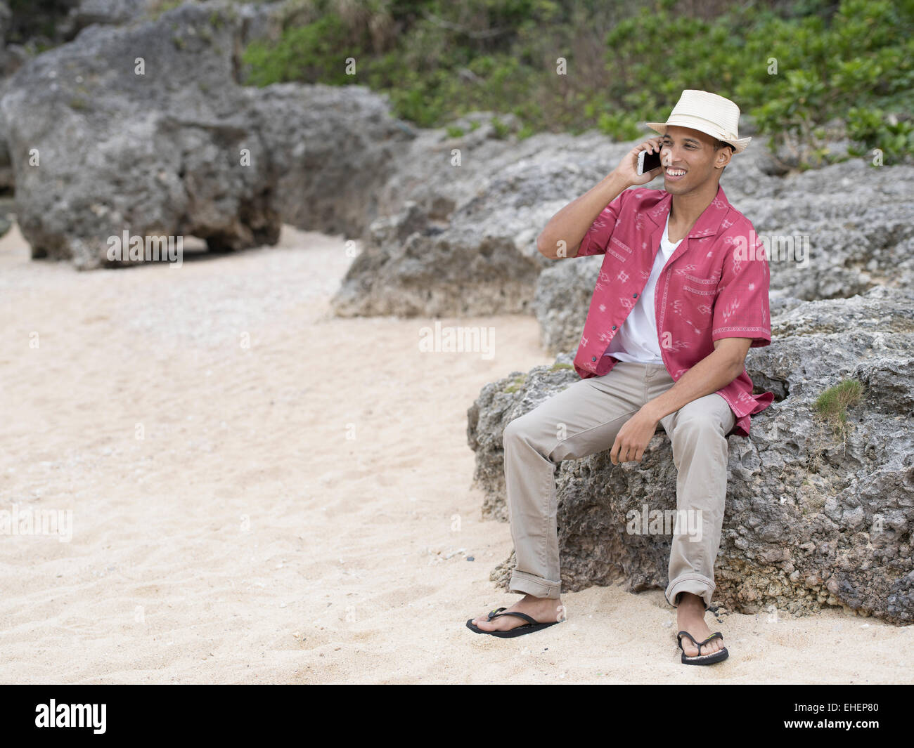 Man calling / telephoning with Apple iphone 6 smartphone while at the beach Stock Photo