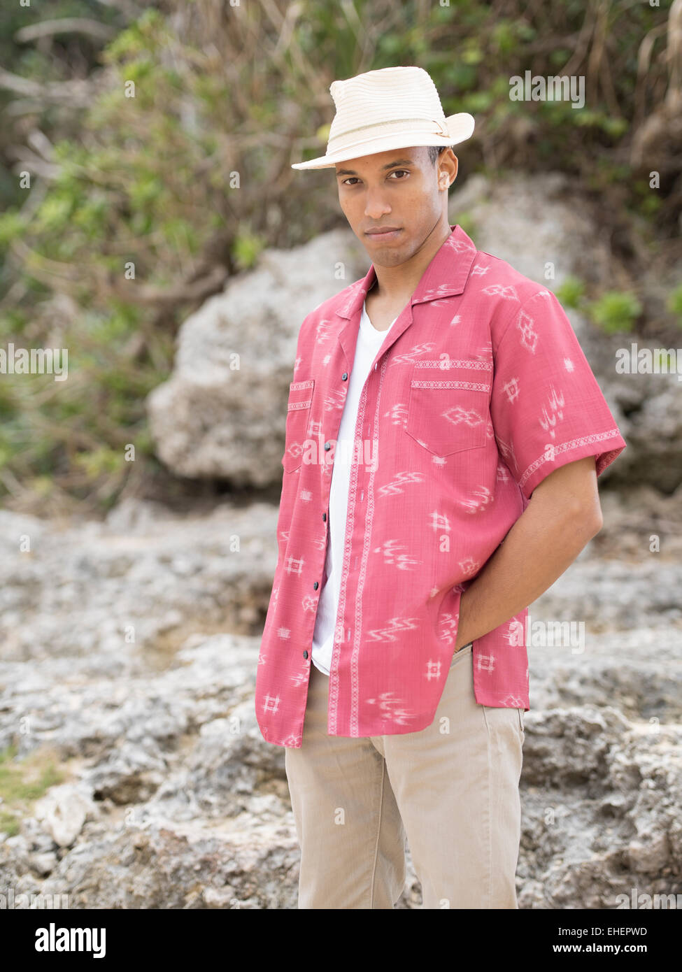 Man wearing Okinawan Kariyushi wear shirt on the beach Stock Photo