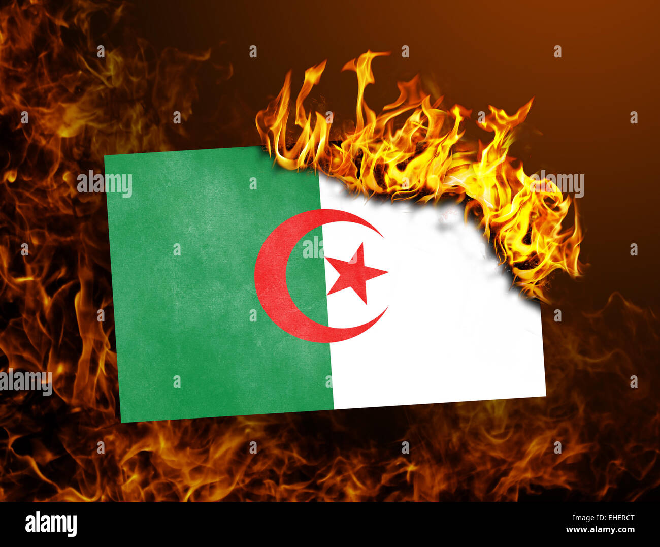 Flag burning - concept of war or crisis - Algeria Stock Photo