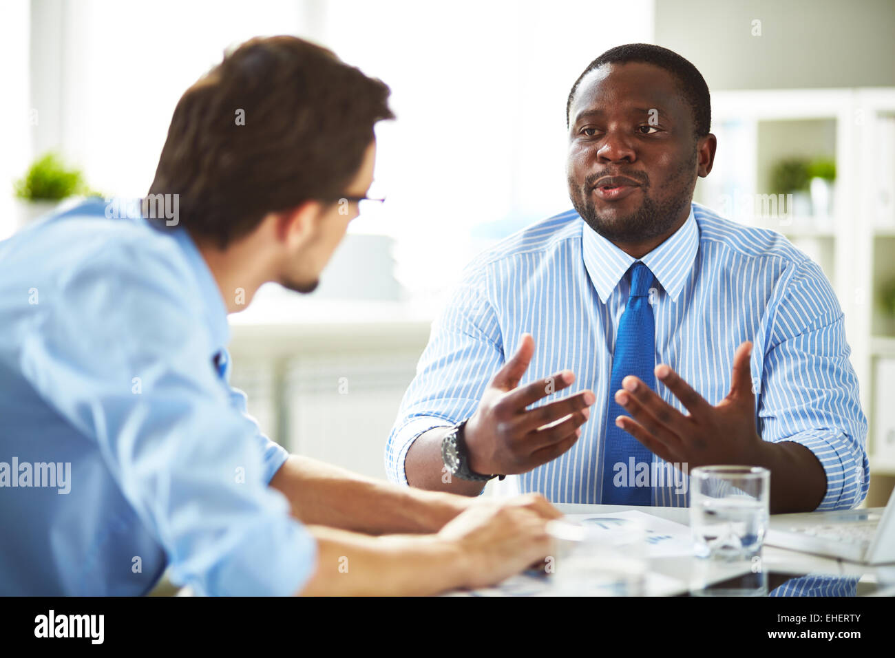 Two managers having conversation Stock Photo - Alamy