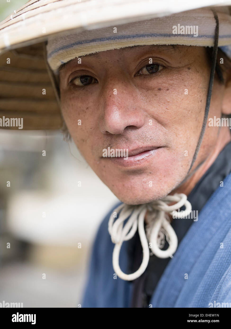 Okinawan man / farmer wearing traditional conical hat, Yomitan, Okinawa Stock Photo