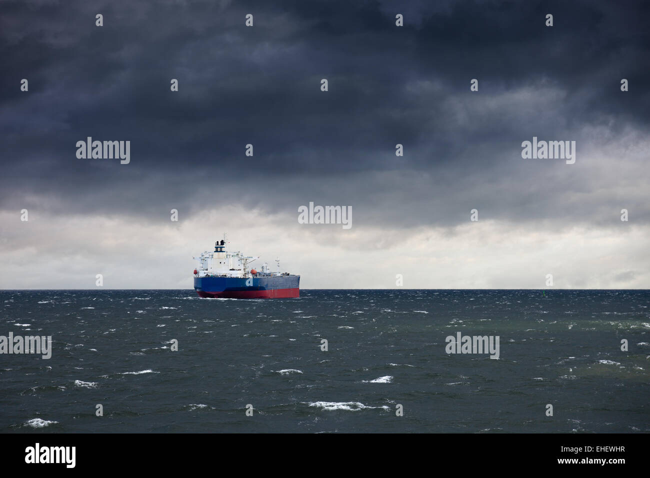 Dark cloudy stormy sky with ship and waves in the sea Stock Photo - Alamy