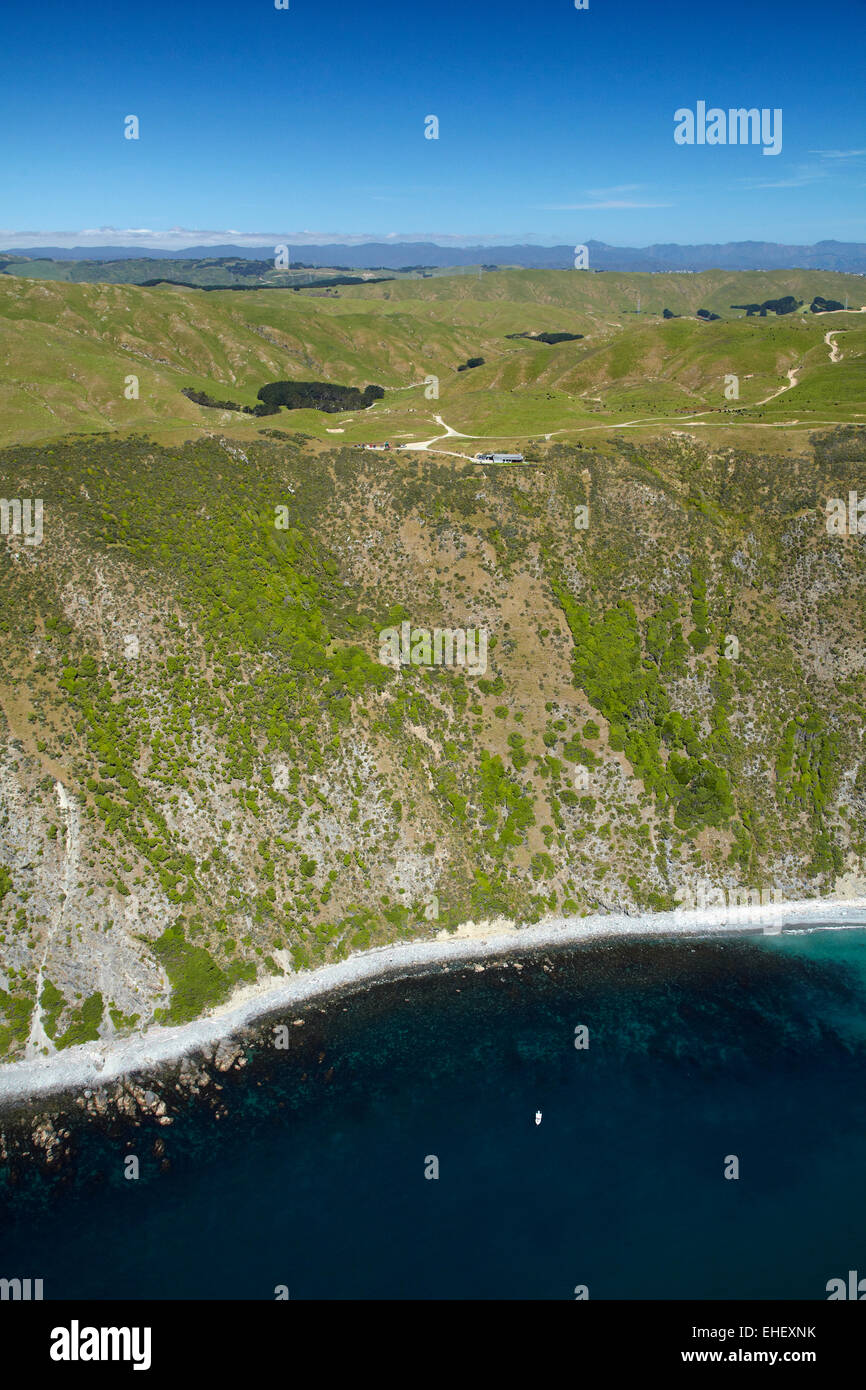 Steep coastline and Boomrock clifftop luxury lodge, near Ohariu Valley, Wellington, North