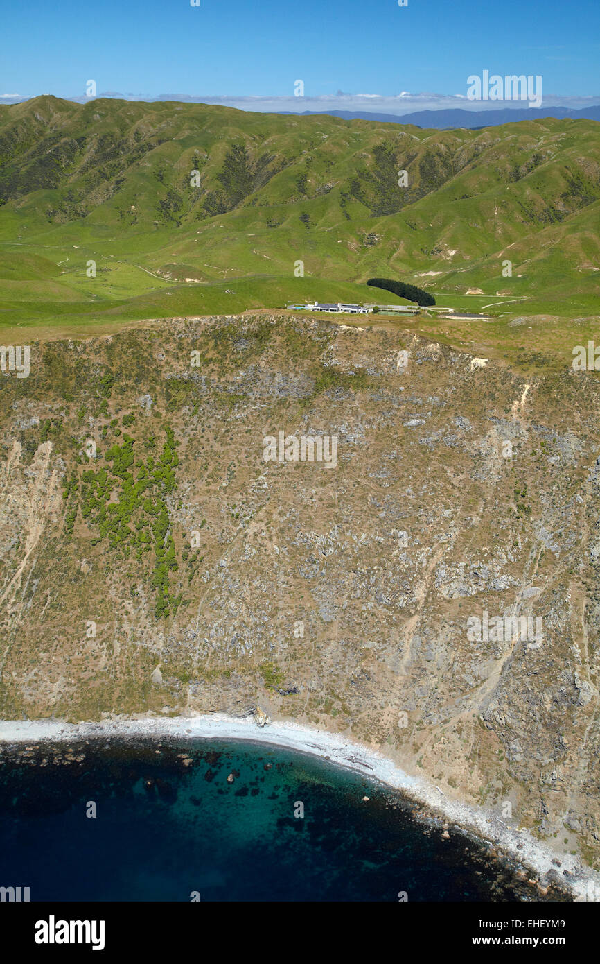 Steep coastline and Boomrock clifftop luxury lodge, near Ohariu Valley, Wellington, North