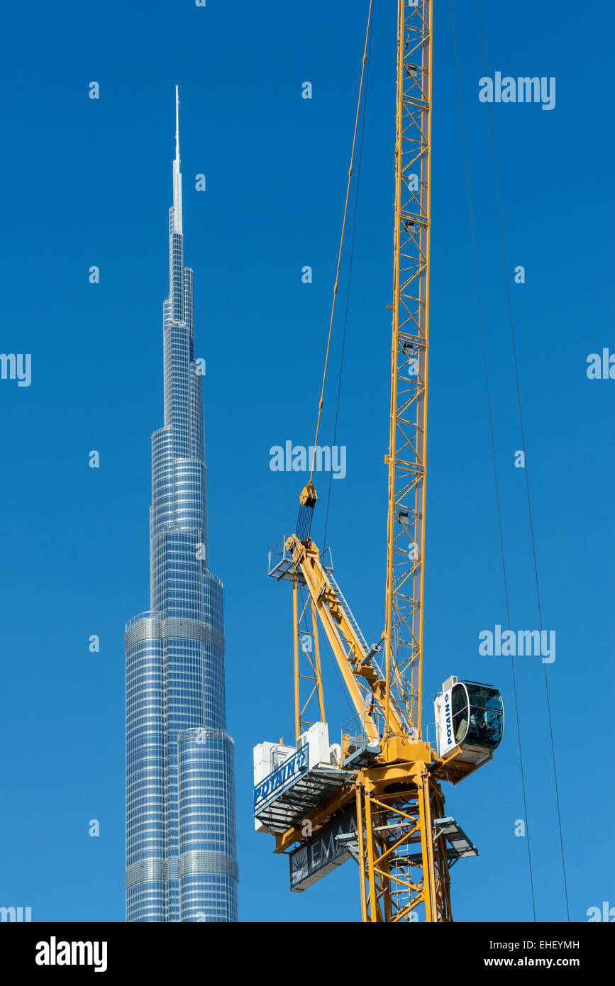 Burj Khalifa and crane at construction site in Dubai United Arab