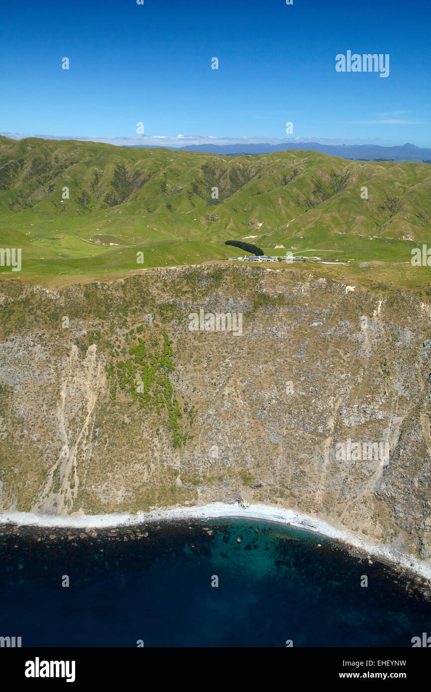 Steep coastline and Boomrock clifftop luxury lodge, near Ohariu Valley, Wellington, North