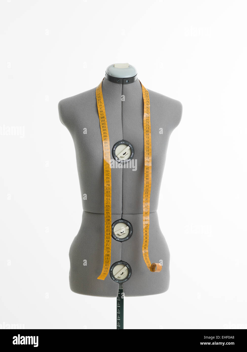 professional dressmakers dummy with measuring tape, on white background