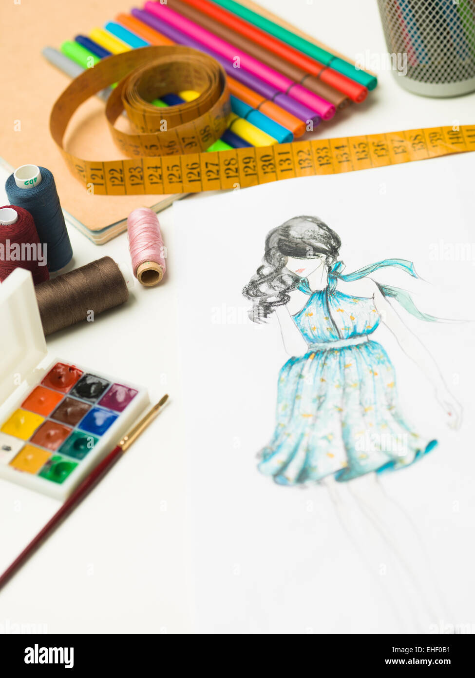 closeup of fashion designer workspace with sketches and designing equipment Stock Photo