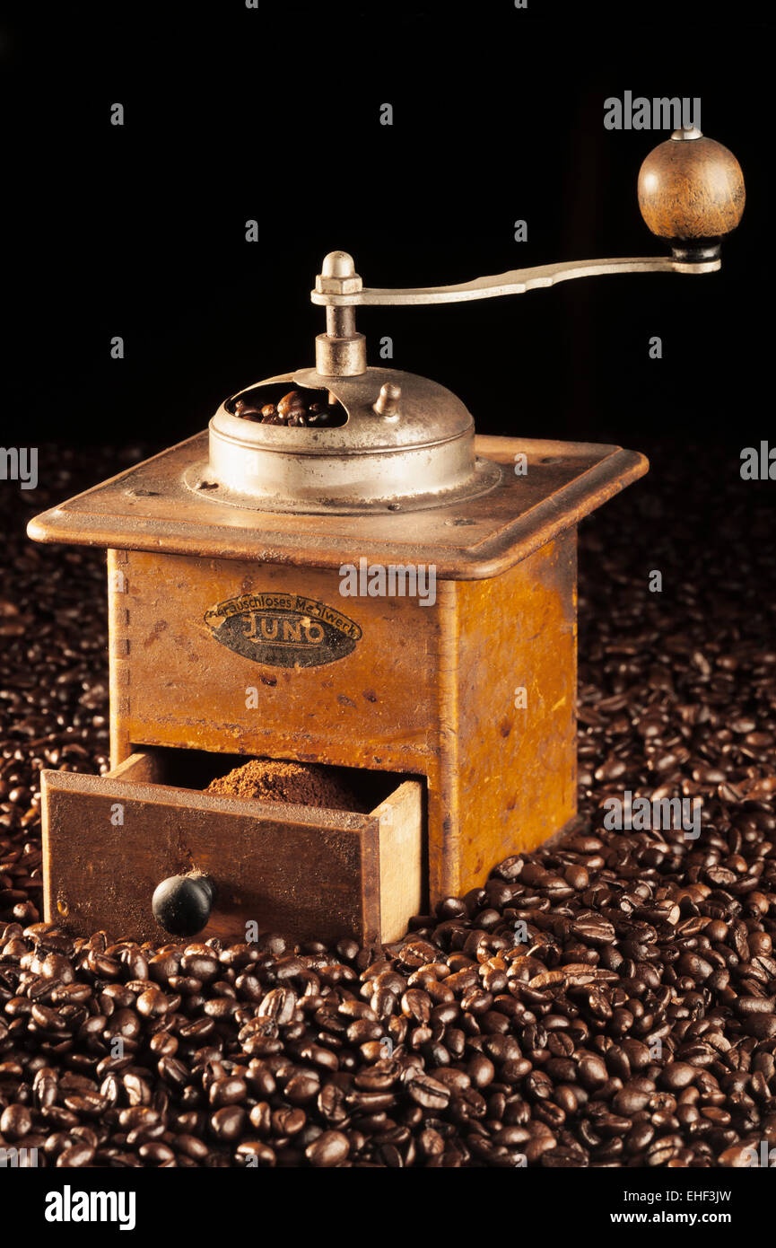 https://c8.alamy.com/comp/EHF3JW/old-coffee-grinder-made-of-wood-circa-1950-on-coffee-beans-EHF3JW.jpg