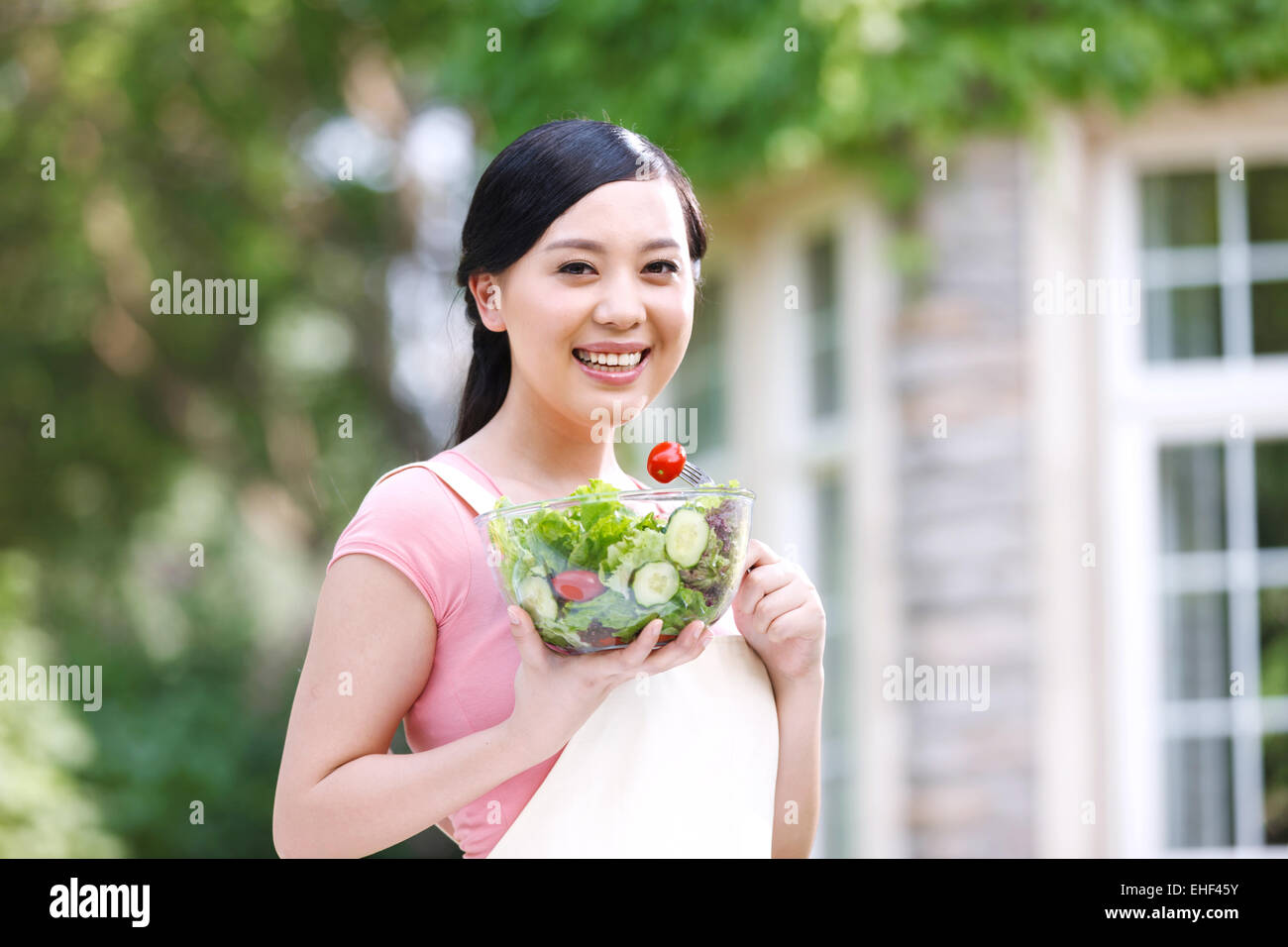 Oriental woman outdoors with vegetable salad Stock Photo