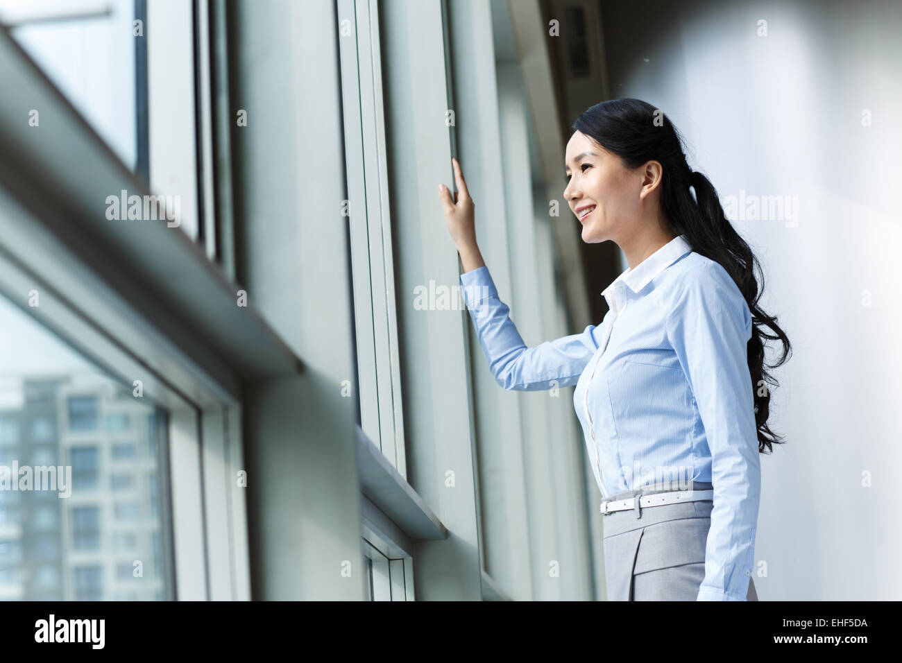 Youth business women looked out through the window Stock Photo - Alamy
