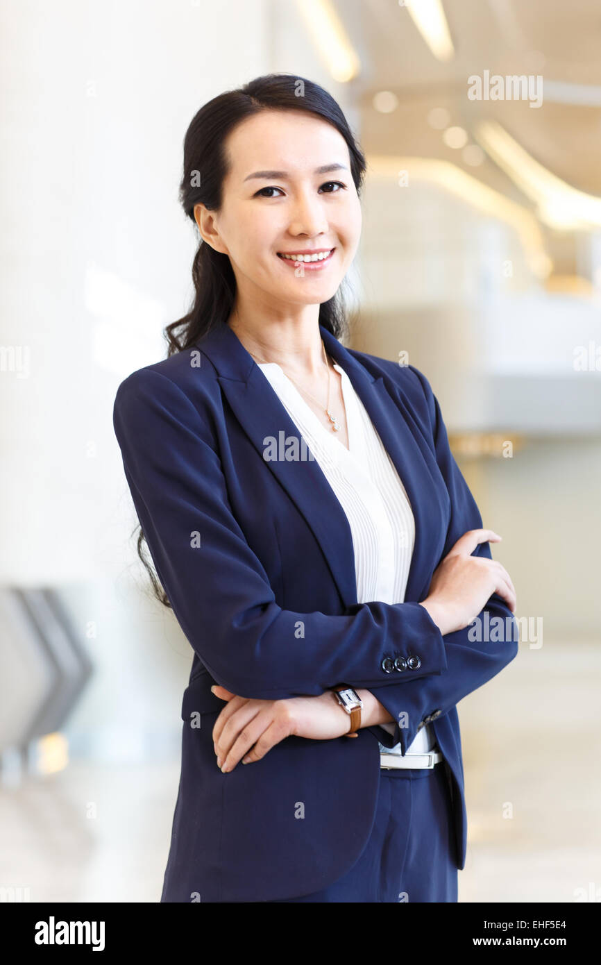 Successful business women, her arms crossed Stock Photo - Alamy