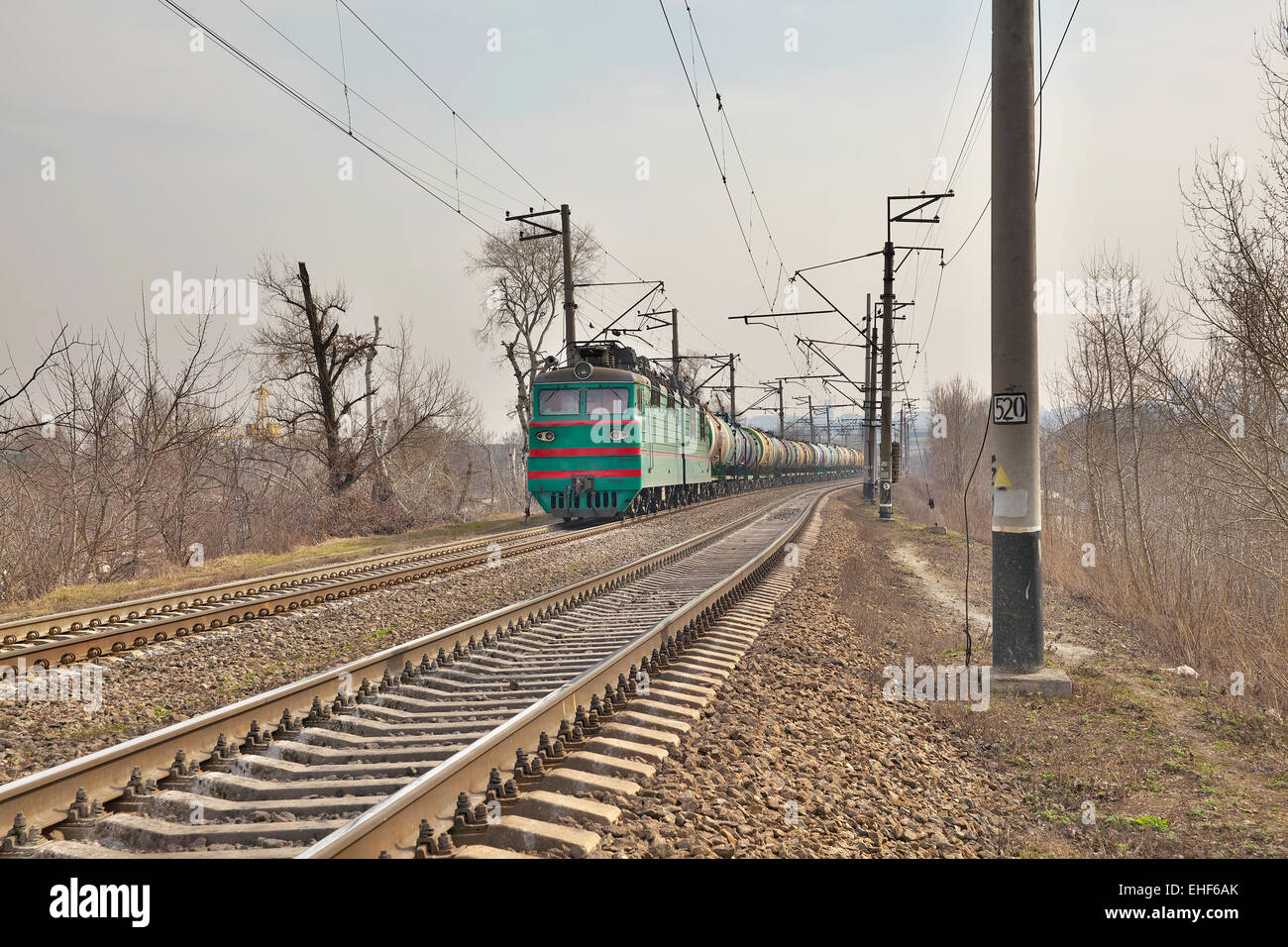 Cargo train driving along the track on the embankment Stock Photo Alamy