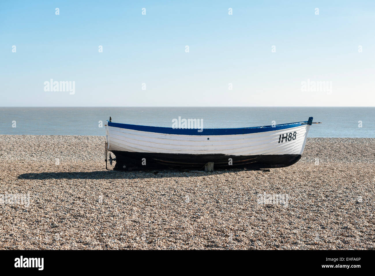 An old wooden fishing boat drawn up on the shingle beach at Aldeburgh ...