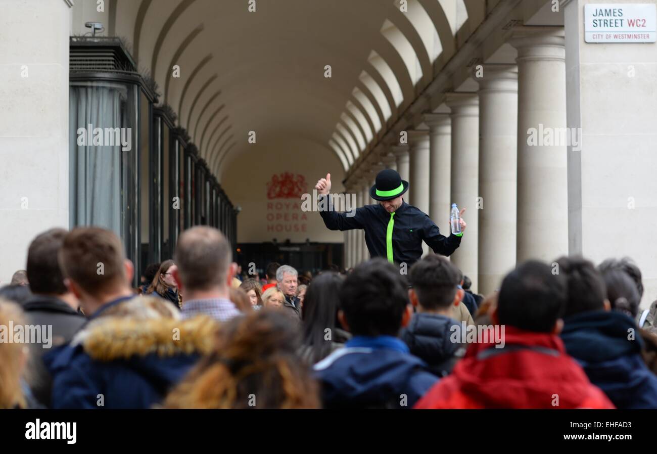 Street entertainer standing on a podium in front of a large crowd on James Street, Covent Garden, London, UK. Stock Photo