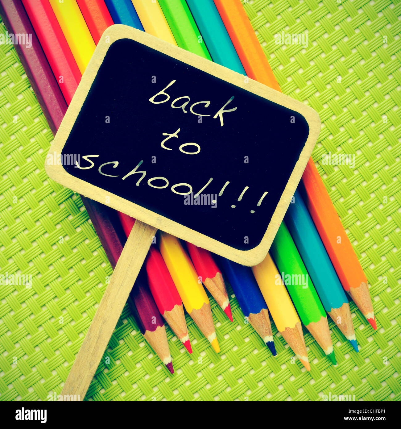 sentence back to school written in a blackboard label and some pencil