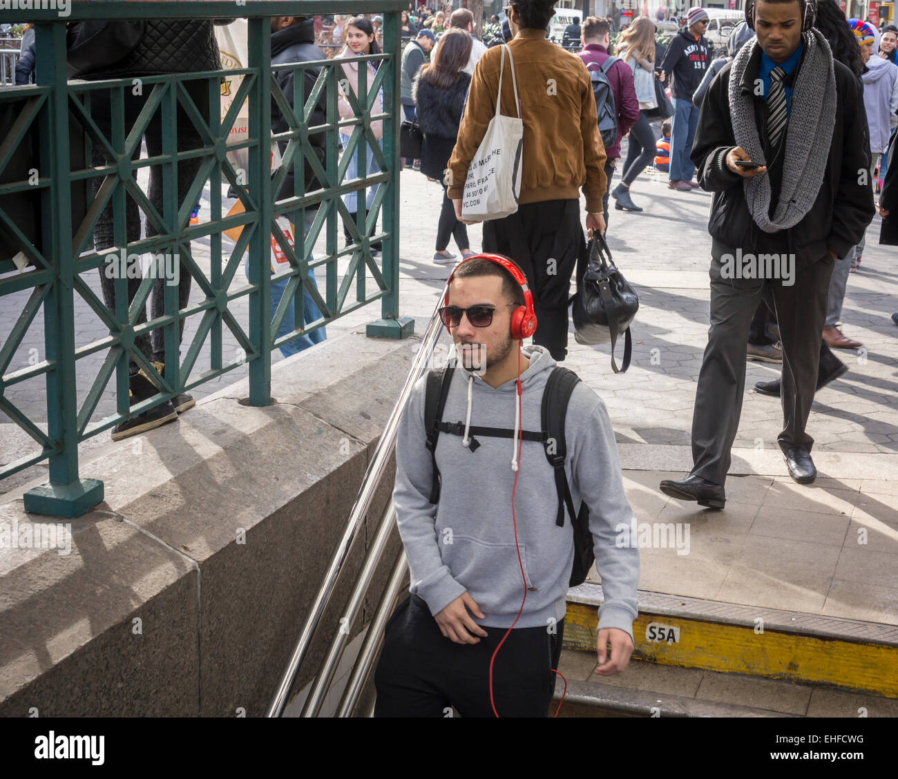 A music listener wears his Beats brand over the ear headphones as he enters the Union Square subway station in New York on Wednesday, March 11, 2015 (© Richard B. Levine) Stock Photo