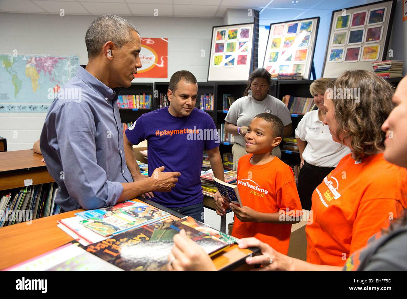 US President Barack Obama speaks with volunteers working in the school library during a National Day of Service and Remembrance project at the Inspired Teaching Demonstration Public Charter School September 11, 2014 in Washington, D.C. Stock Photo