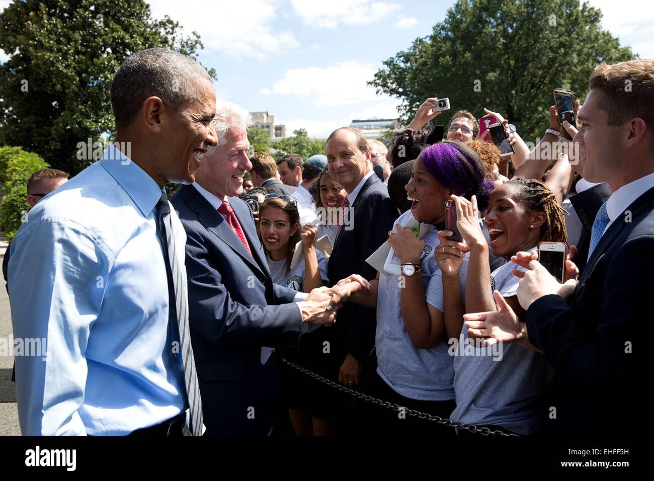 US President Barack Obama and former President Bill Clinton greet supporters during the 20th anniversary of the AmeriCorps national service program on the South Lawn of the White House September 12, 2014 in Washington, DC Stock Photo