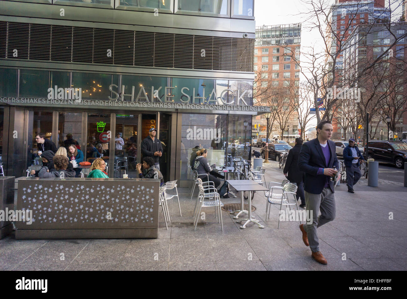 Burgers lovers lunch at the Shake Shack in the Tribeca neighborhood of New York on Wednesday, March 11, 2015.  Shack Shake reported revenue growth of 51 percent in its first quarter since its IPO. The burger joint has 63 stores and plans to open 10 more a year possibly reaching 450 stores. (© Richard B. Levine) Stock Photo