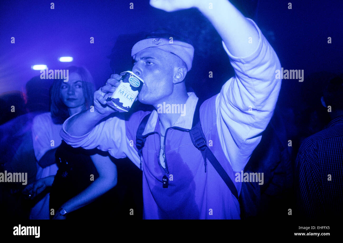 Man dancing whilst drinking milk at Colours at The Arches Glasgow 13th June 1998. Stock Photo